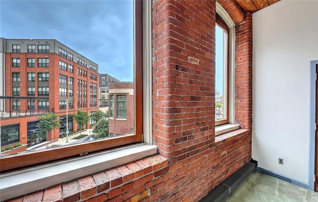 116 Chestnut St Unit G, Providence, RI 02903 - detailed view of brick wall, baseboards, and finished concrete floors