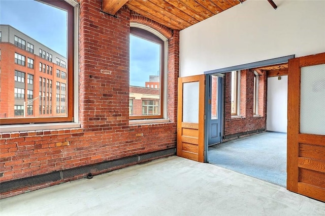 116 Chestnut St Unit G, Providence, RI 02903 - carpeted empty room with brick wall and wooden ceiling