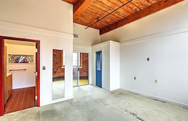 116 Chestnut St Unit G, Providence, RI 02903 - unfurnished bedroom featuring wooden ceiling with exposed beams, baseboards, a towering ceiling, and carpet floors