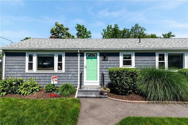 205 Carolyn St, Warwick, RI 02886 - view of front facade with a chimney and roof with shingles