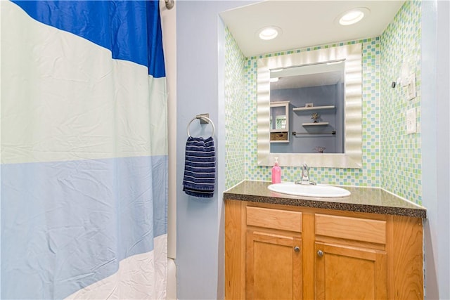 205 Carolyn St, Warwick, RI 02886 - bathroom with vanity, backsplash, and wallpapered walls