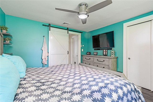 205 Carolyn St, Warwick, RI 02886 - bedroom featuring a barn door, a closet, wood finished floors, and ceiling fan