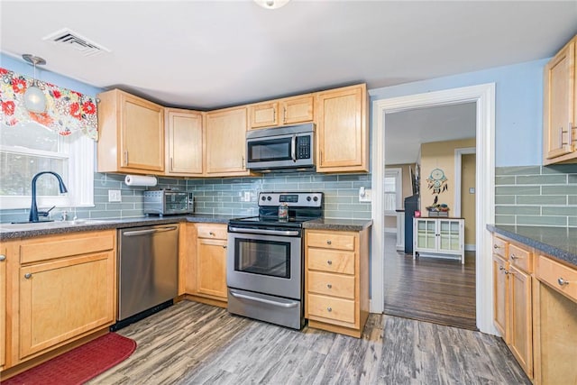 205 Carolyn St, Warwick, RI 02886 - kitchen featuring stainless steel appliances, light brown cabinetry, and wood finished floors