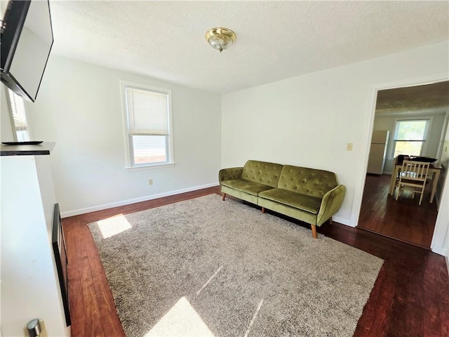 5 Rosemont Ter, North Providence, RI 02911 - living room with dark wood-type flooring, a textured ceiling, and baseboards