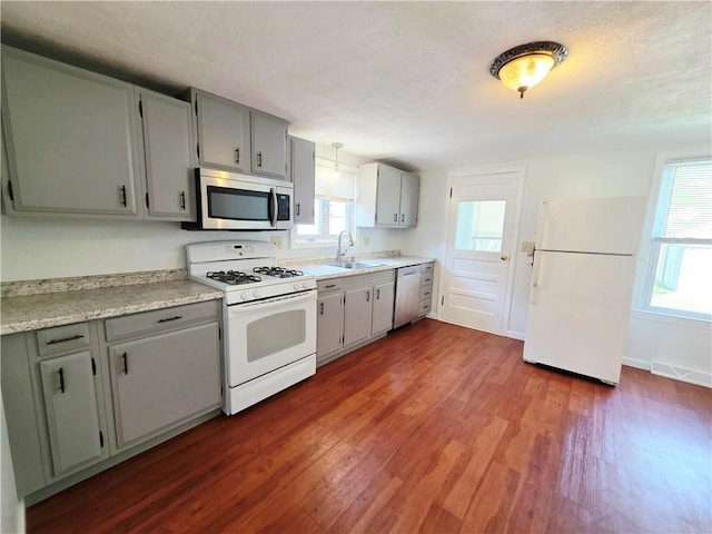 5 Rosemont Ter, North Providence, RI 02911 - kitchen featuring stainless steel appliances, a sink, dark wood finished floors, gray cabinets, and light countertops