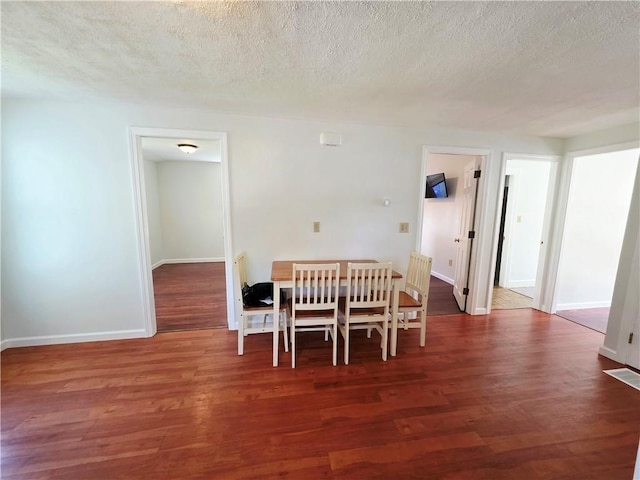 5 Rosemont Ter, North Providence, RI 02911 - dining area with wood finished floors, a textured ceiling, and baseboards