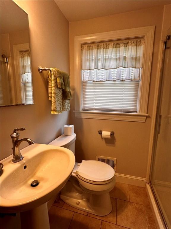 100 Benedict St, Pawtucket, RI 02861 - full bathroom with a shower stall, tile patterned flooring, toilet, a sink, and baseboards
