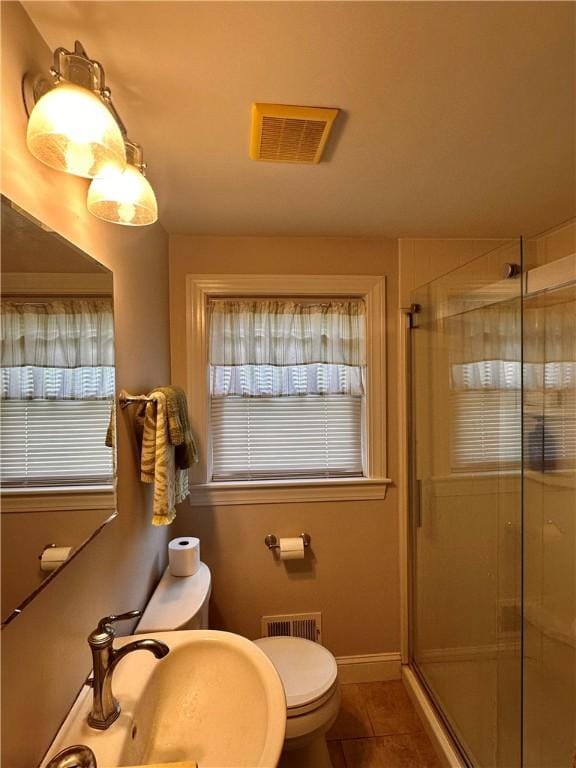 100 Benedict St, Pawtucket, RI 02861 - bathroom with a shower stall, tile patterned flooring, toilet, a sink, and plenty of natural light