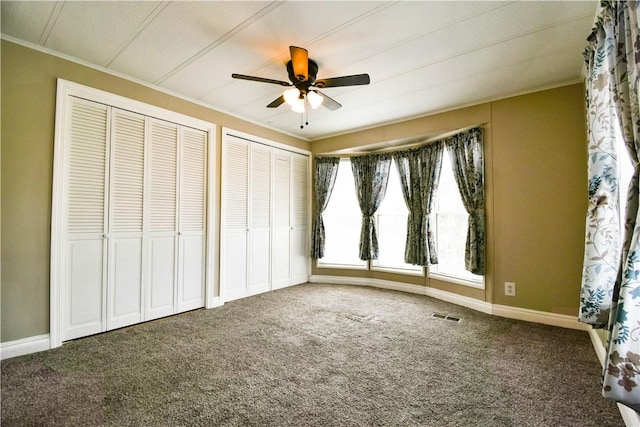 40 Lowell Ave, Pawtucket, RI 02861 - unfurnished bedroom with ornamental molding, two closets, carpet floors, baseboards, and ceiling fan