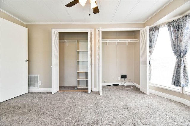 40 Lowell Ave, Pawtucket, RI 02861 - unfurnished bedroom featuring multiple closets, multiple windows, carpet flooring, and ornamental molding