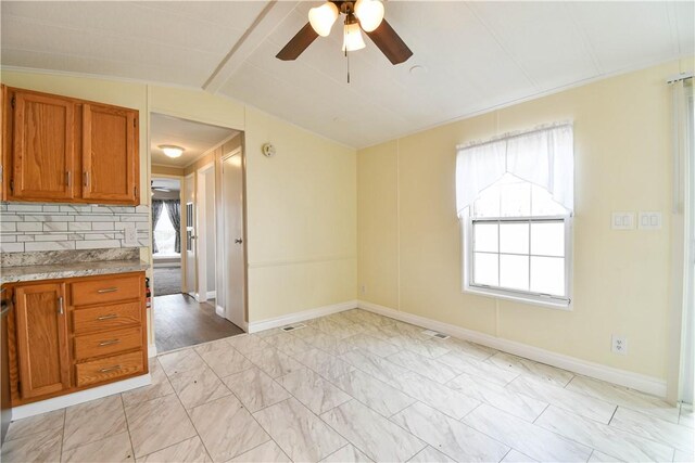 40 Lowell Ave, Pawtucket, RI 02861 - kitchen featuring brown cabinets, ceiling fan, lofted ceiling, and baseboards