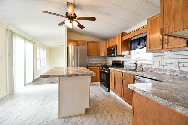 40 Lowell Ave, Pawtucket, RI 02861 - kitchen featuring appliances with stainless steel finishes, vaulted ceiling, a kitchen island, plenty of natural light, and a sink