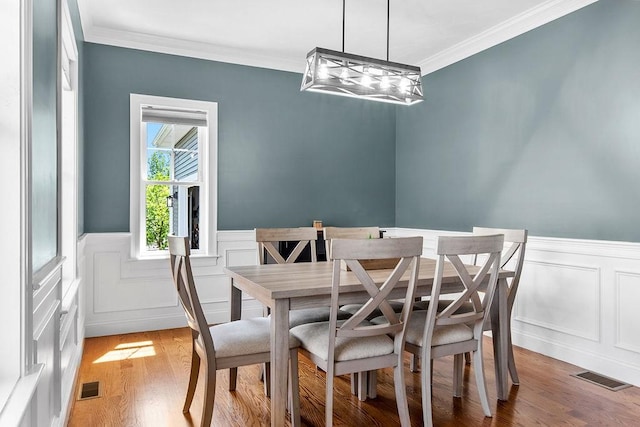 13 Vincent Way, Cumberland, RI 02864 - dining room with crown molding, a wainscoted wall, light wood-type flooring, a decorative wall, and a chandelier