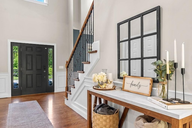 13 Vincent Way, Cumberland, RI 02864 - foyer entrance featuring a high ceiling, plenty of natural light, stairway, wood finished floors, and a wainscoted wall