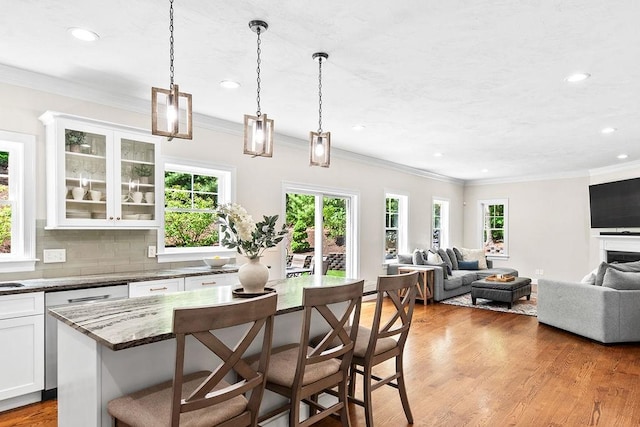 13 Vincent Way, Cumberland, RI 02864 - kitchen featuring a breakfast bar, recessed lighting, open floor plan, white cabinetry, and light wood-style floors