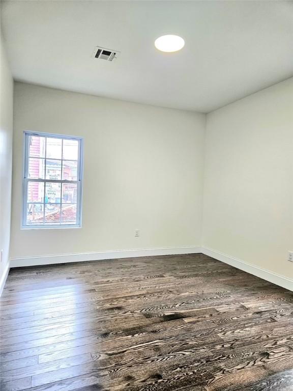 90 Grove St, Providence, RI 02903 - unfurnished room with dark wood-style flooring and baseboards
