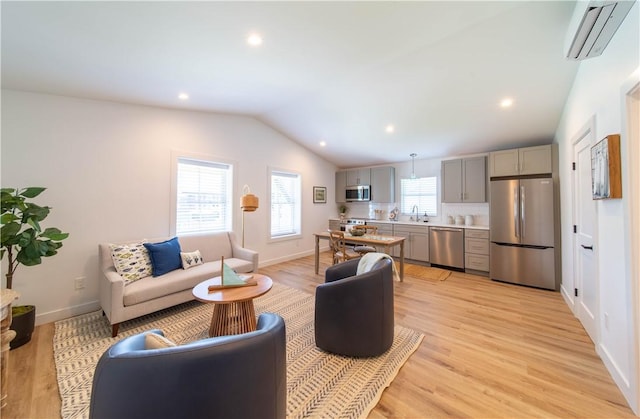 32 Exchange St Unit 104, East Greenwich, RI 02818 - living room with a wall unit AC, lofted ceiling, light wood finished floors, recessed lighting, and baseboards
