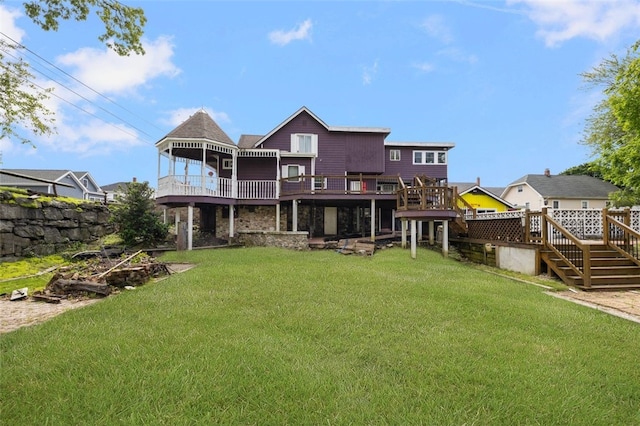 204 Reservoir Ave, Lincoln, RI 02865 - back of property with stairs, a wooden deck, stone siding, and a yard