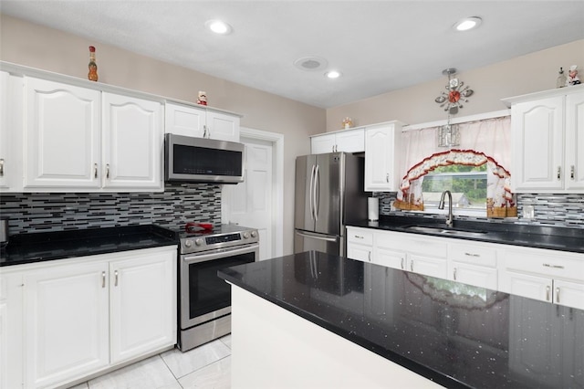 204 Reservoir Ave, Lincoln, RI 02865 - kitchen with appliances with stainless steel finishes, a sink, tasteful backsplash, white cabinetry, and recessed lighting