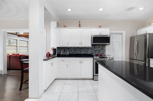 204 Reservoir Ave, Lincoln, RI 02865 - kitchen with appliances with stainless steel finishes, white cabinets, decorative backsplash, and recessed lighting
