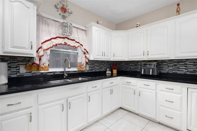 204 Reservoir Ave, Lincoln, RI 02865 - kitchen featuring a sink, tasteful backsplash, light tile patterned floors, and white cabinets