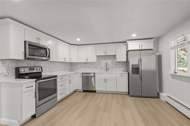 196 Stillwater Rd, Smithfield, RI 02917 - kitchen with appliances with stainless steel finishes, a baseboard radiator, a sink, light wood finished floors, and light countertops