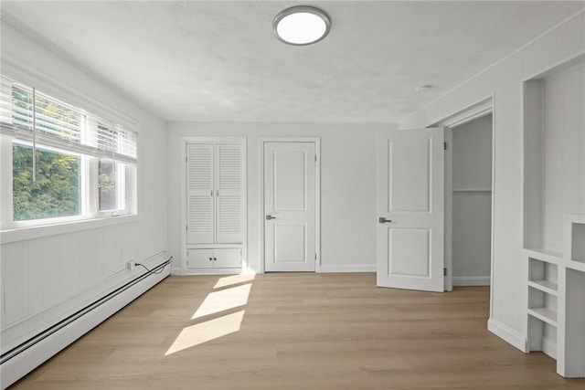 196 Stillwater Rd, Smithfield, RI 02917 - unfurnished bedroom featuring a baseboard heating unit, light wood-type flooring, and baseboards
