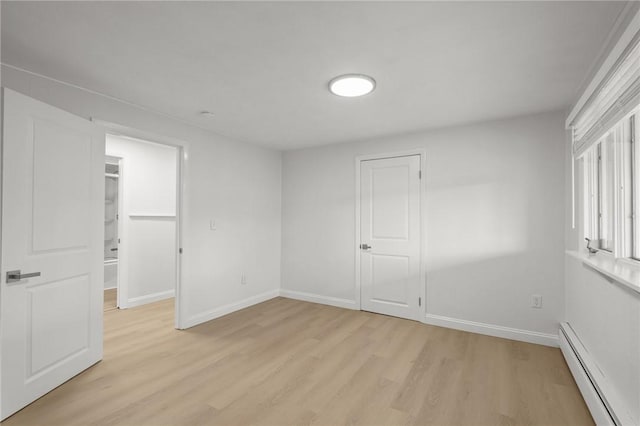 196 Stillwater Rd, Smithfield, RI 02917 - unfurnished bedroom with baseboard heating, light wood-style flooring, a closet, and baseboards