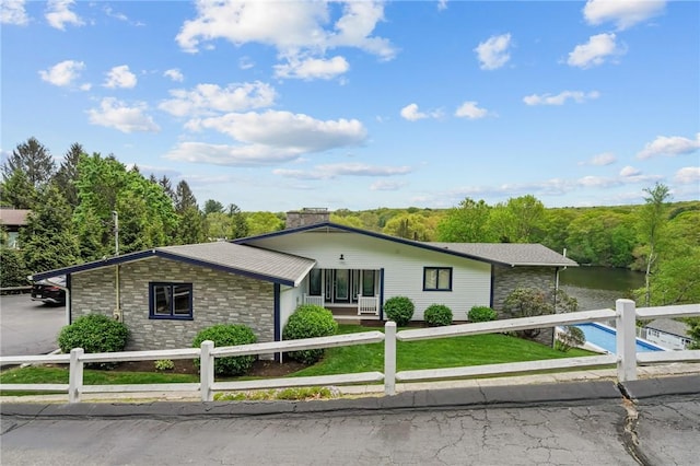 196 Stillwater Rd, Smithfield, RI 02917 - ranch-style house with a fenced front yard, stone siding, a water view, and a chimney