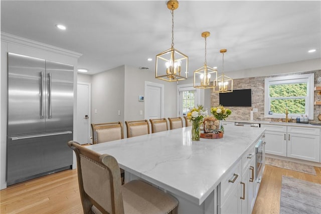 196 Stillwater Rd, Smithfield, RI 02917 - kitchen featuring stainless steel appliances, a chandelier, white cabinetry, recessed lighting, and light stone counters
