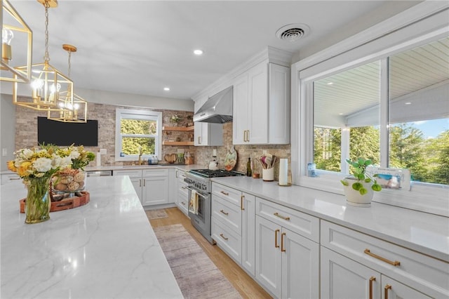 196 Stillwater Rd, Smithfield, RI 02917 - kitchen featuring wall chimney range hood, stainless steel range, a chandelier, decorative backsplash, and white cabinetry