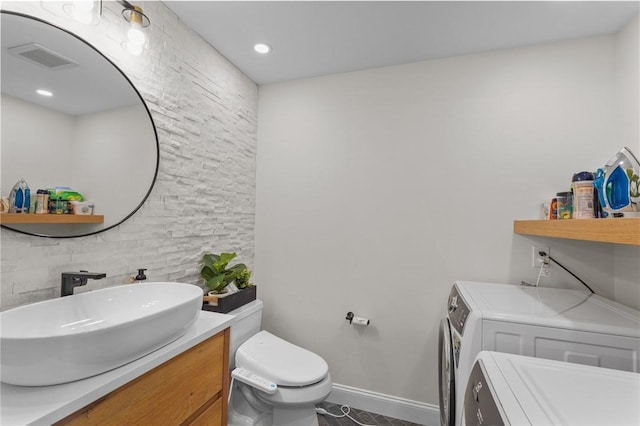 196 Stillwater Rd, Smithfield, RI 02917 - bathroom with washer and clothes dryer, toilet, vanity, baseboards, and tile patterned floors