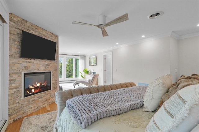 196 Stillwater Rd, Smithfield, RI 02917 - bedroom with wood finished floors, crown molding, a fireplace, a baseboard radiator, and recessed lighting