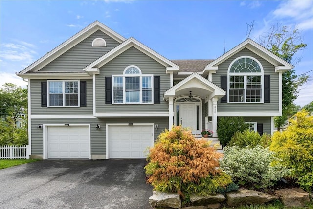228 Morse Ave, Woonsocket, RI 02895 - bi-level home featuring driveway and an attached garage