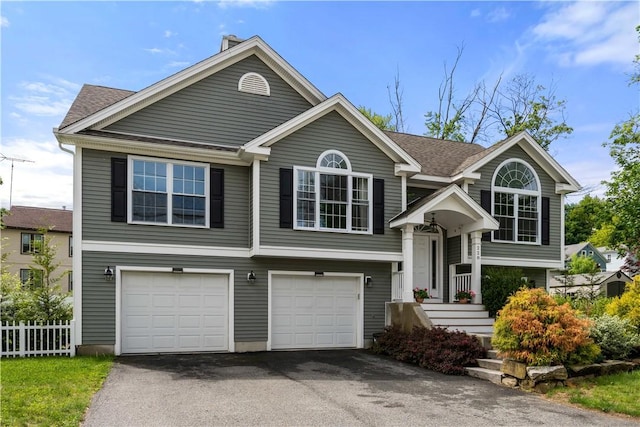 228 Morse Ave, Woonsocket, RI 02895 - bi-level home with asphalt driveway, a garage, and a shingled roof