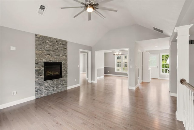 228 Morse Ave, Woonsocket, RI 02895 - unfurnished living room with a ceiling fan, wood finished floors, a fireplace, a chandelier, and high vaulted ceiling
