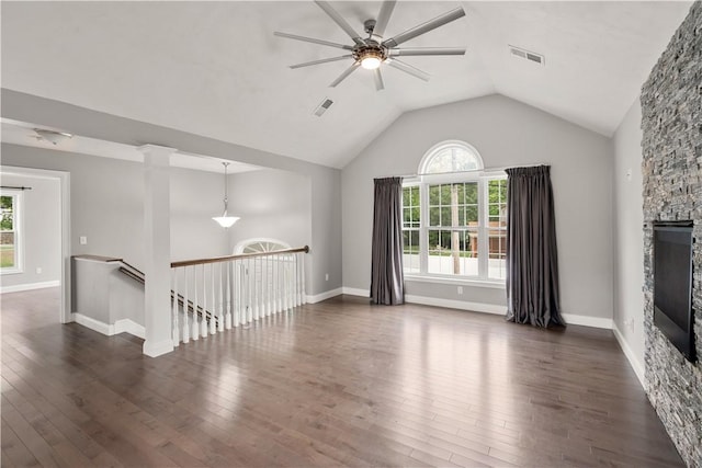 228 Morse Ave, Woonsocket, RI 02895 - unfurnished room featuring a ceiling fan, plenty of natural light, dark wood finished floors, vaulted ceiling, and a stone fireplace