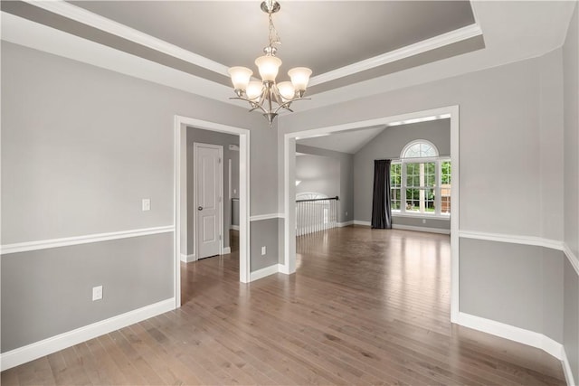 228 Morse Ave, Woonsocket, RI 02895 - spare room featuring a chandelier, wood finished floors, baseboards, and a raised ceiling