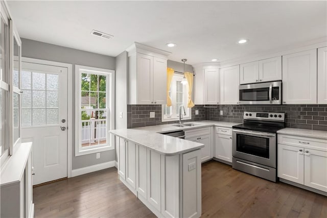 228 Morse Ave, Woonsocket, RI 02895 - kitchen featuring appliances with stainless steel finishes, a sink, a peninsula, dark wood-style flooring, and recessed lighting