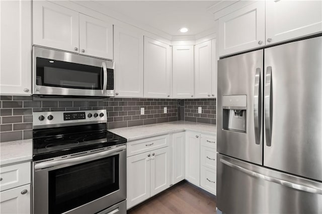 228 Morse Ave, Woonsocket, RI 02895 - kitchen featuring stainless steel appliances, white cabinets, light stone countertops, dark wood-style floors, and recessed lighting