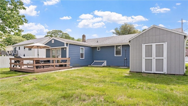 21 Meadowrue Trl, Narragansett, RI 02874 - rear view of property featuring a wooden deck, a chimney, and a yard
