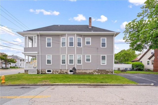 1362 Newport Ave, Pawtucket, RI 02861 - view of home's exterior with a chimney, a yard, and uncovered parking