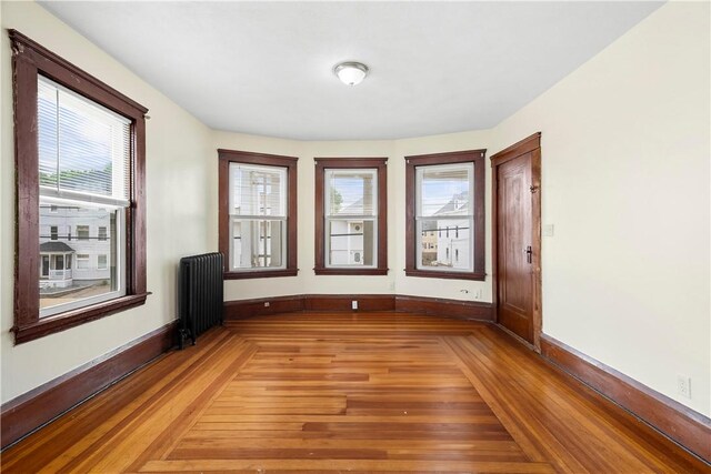 1362 Newport Ave, Pawtucket, RI 02861 - empty room featuring radiator, baseboards, and light wood-style flooring