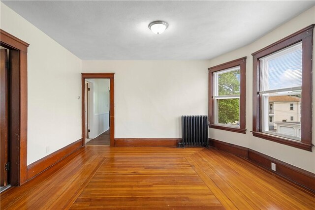 1362 Newport Ave, Pawtucket, RI 02861 - spare room with radiator, baseboards, and light wood-style flooring
