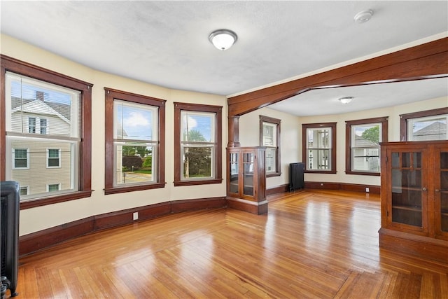 1362 Newport Ave, Pawtucket, RI 02861 - unfurnished living room featuring healthy amount of natural light, baseboards, and light wood-style flooring