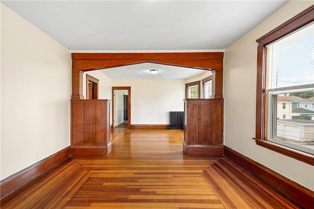 1362 Newport Ave, Pawtucket, RI 02861 - hall with radiator, baseboards, and parquet floors