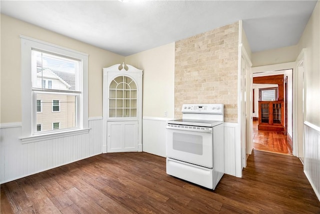 1362 Newport Ave, Pawtucket, RI 02861 - kitchen featuring white electric stove, a wainscoted wall, dark wood finished floors, and light countertops
