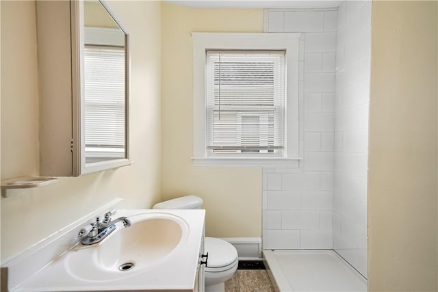 1362 Newport Ave, Pawtucket, RI 02861 - bathroom featuring toilet, vanity, and a tile shower