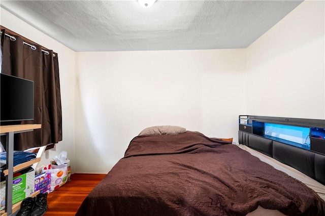 1362 Newport Ave, Pawtucket, RI 02861 - bedroom with wood finished floors and a textured ceiling