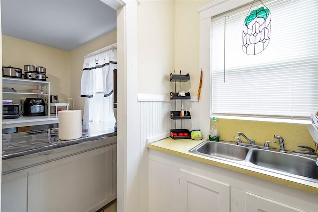 1362 Newport Ave, Pawtucket, RI 02861 - kitchen with plenty of natural light, light countertops, a wainscoted wall, and a sink